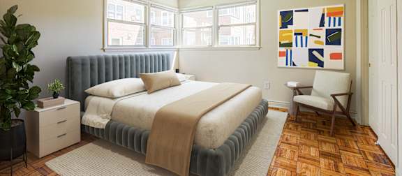 A bedroom with a bed, chair, and a ceiling fan. at Park Georgetown Apartments, Arlington, VA, 22209